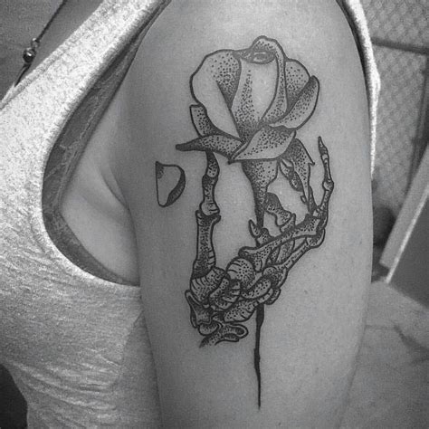 Skeleton Hand Holding Rose Tattoo