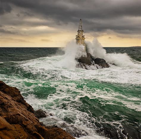 Lighthouse In A Stormy Sea Photograph By Evgeni Ivanov
