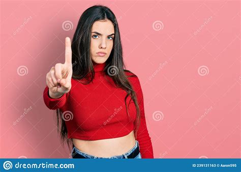 Young Brunette Teenager Wearing Red Turtleneck Sweater Pointing With Finger Up And Angry