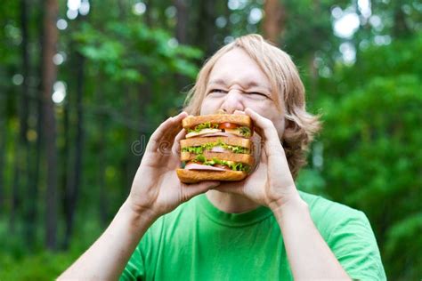 Young Man Holding Piece Big Sausage Sandwich On Plate Student Eats