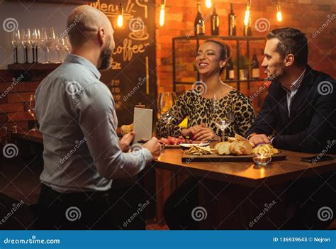 Couple Talking To Bartender Behind Bar Counter In A Cafe Stock Image Image Of Adult Girl