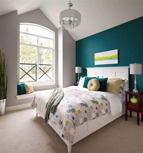 A Bedroom With Teal Walls And White Bedding In The Center Along With A