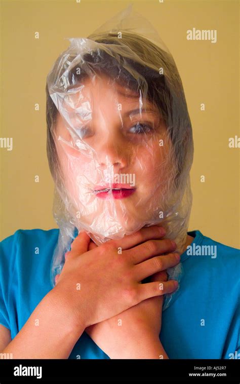 Young Girl With Head In A Plastic Bag To Illustrate The Editorial