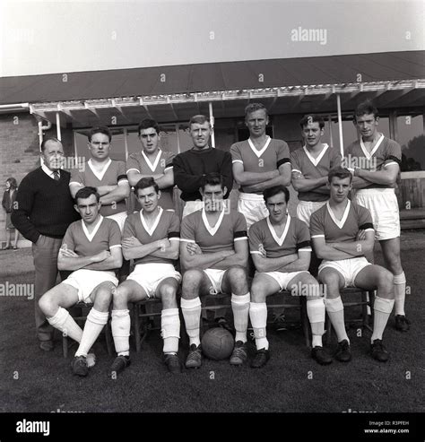 1965 historical amateur football male players in the soccer kit of the era sitting and