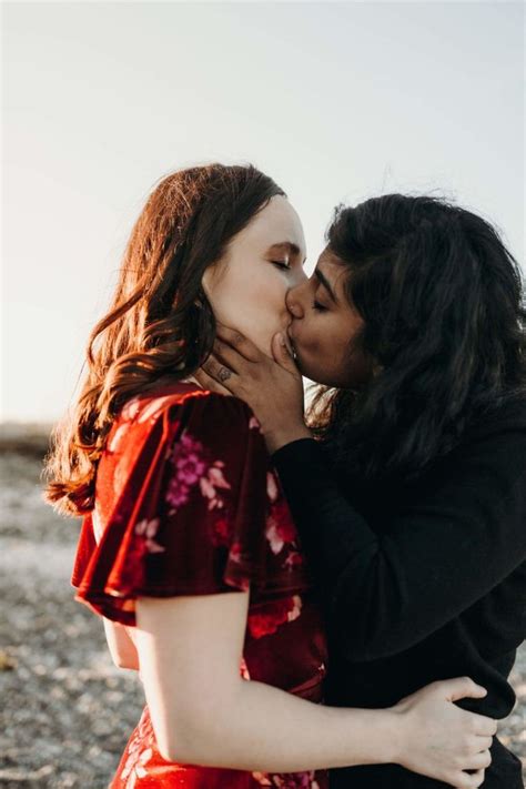 Two Women Kissing Each Other On The Beach