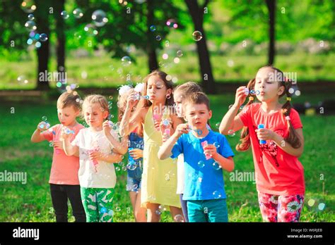 The Group Of Children Blowing Soap Bubbles Stock Photo Alamy