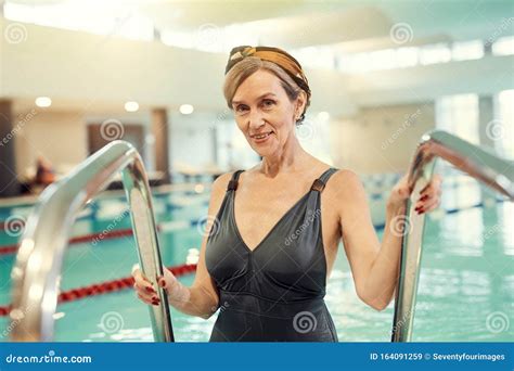 Smiling Mature Woman Entering Swimming Pool Stock Image Image Of Activity Exercising 164091259
