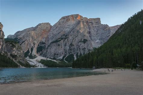 Tourists On The Beach Of Lake Braies With Awesome Dolomitic Mountains