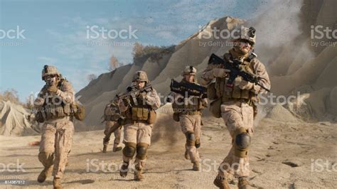 Squad Of Fully Equipped Armed Soldiers Running And Attacking During