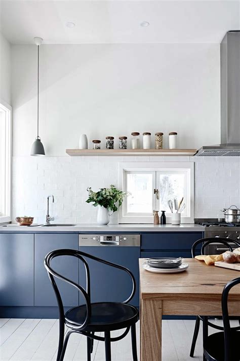 This minimalist swedish cottage set on an island outside stockholm couldn't be more charming. Dark minimalist kitchen inspiration - cate st hill