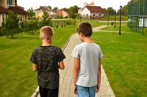Two Friend Boys Go Along The Path In The Summer Children`s Boy