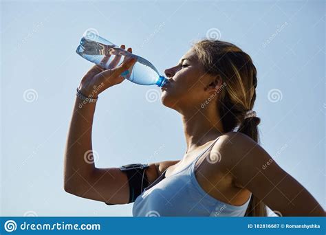 Sporty Woman Drinking Water Against The Stadium Stock Image Image Of