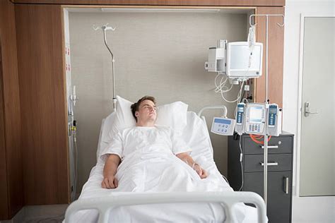 7400 Man Laying In Hospital Bed Stock Photos Pictures And Royalty Free