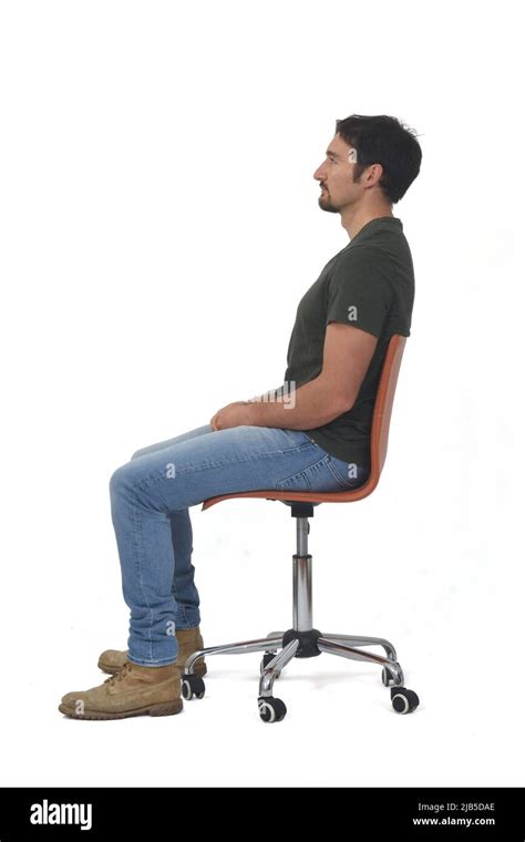 Side View Of A Full Portrait Of Man Sitting On Chair On Whige
