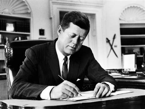President John F Kennedy Working At His Desk In The Oval Office Of The