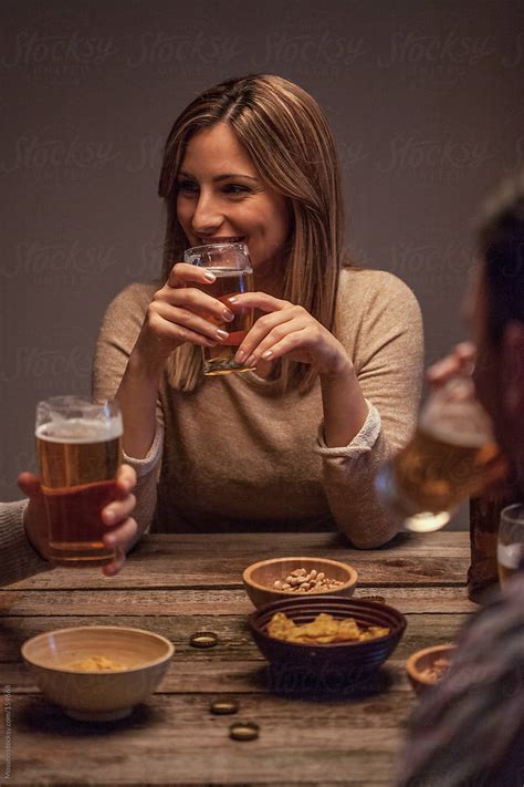 Woman Laughing And Drinking Beer With Friends By Stocksy Contributor Mosuno Stocksy
