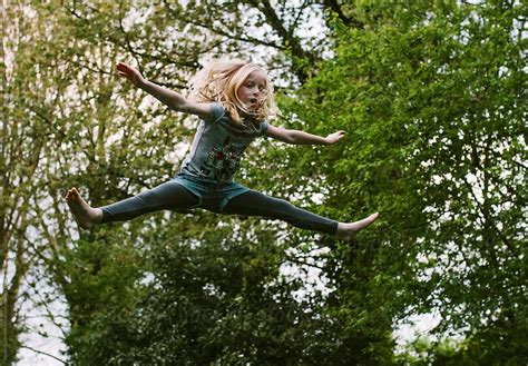 A Little Girl Jumping High In The Air By Stocksy Contributor Helen