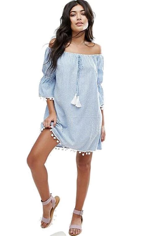 elevate your look with this blue and white stripe off shoulder top accented with white pompom