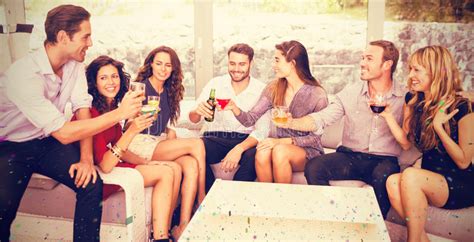 Composite Image Of Friends Talking And Having Drinks Stock Image