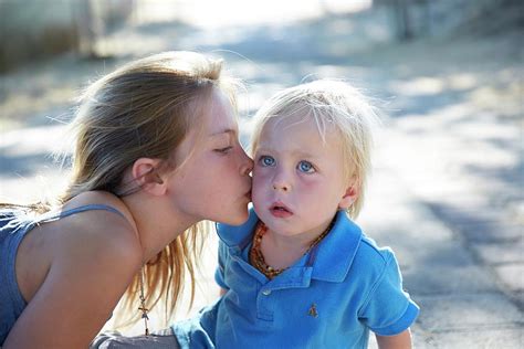 Girl Kissing Brother On Cheek Photograph By Ruth Jenkinson Fine Art