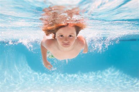 Child In Pool In Summer Day Young Boy Swim And Dive Underwater Under