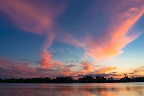Amazing Pink And Blue Sunset Sky Reflected In River Water Stock Image