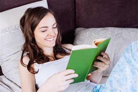 Woman Lying In Bed While Reading A Book Stock Image Image Of House Bedding 68114497