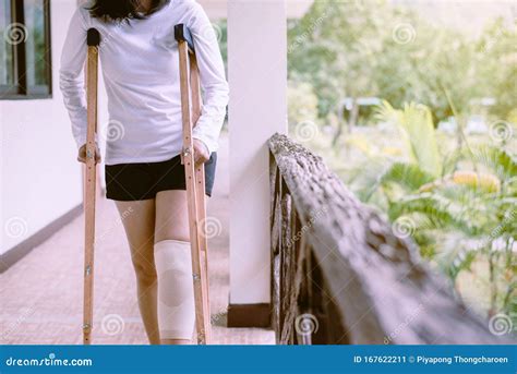 Woman Using Crutches And Broken Legs For Walking Outdoor Stock Image