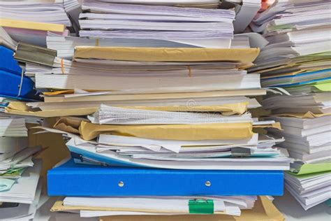 Pile Of Documents On Desk Stack Up High Waiting To Be Managed Stock