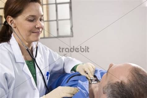 Female Doctor Using A Stethoscope For Auscultating A Patient Down