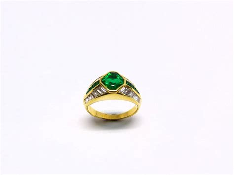 1 Magnificent Emerald Set In An 18 Karat Yellow Gold Ring With Diamonds