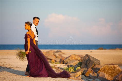 Young Romantic Couple Relaxing On The Beach Watching The Sunset Stock Image Image Of