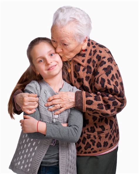 Premium Photo Grandmother Kissing Her Granddaughter On A White Background
