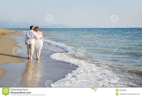 Romantic Couple Walking Together On The Beach Stock Photo