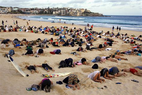 Australians Bury Heads In Sand To Mock Government Climate