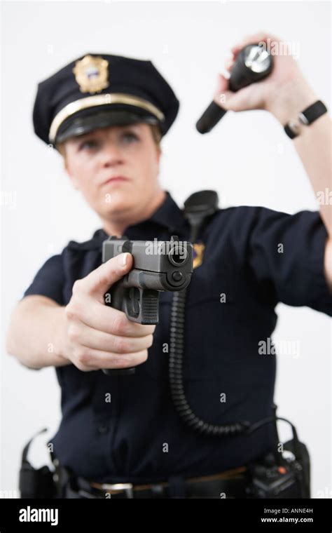 Police Woman Pointing Handgun And Holding Flashlight Stock Photo Alamy