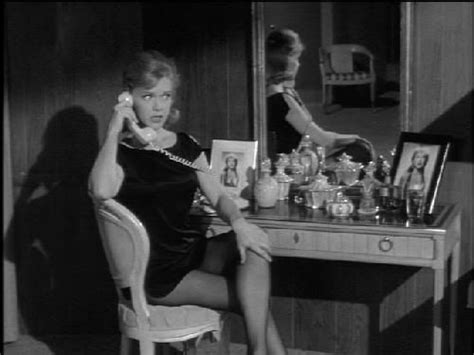 A Woman Sitting In Front Of A Vanity Talking On The Phone