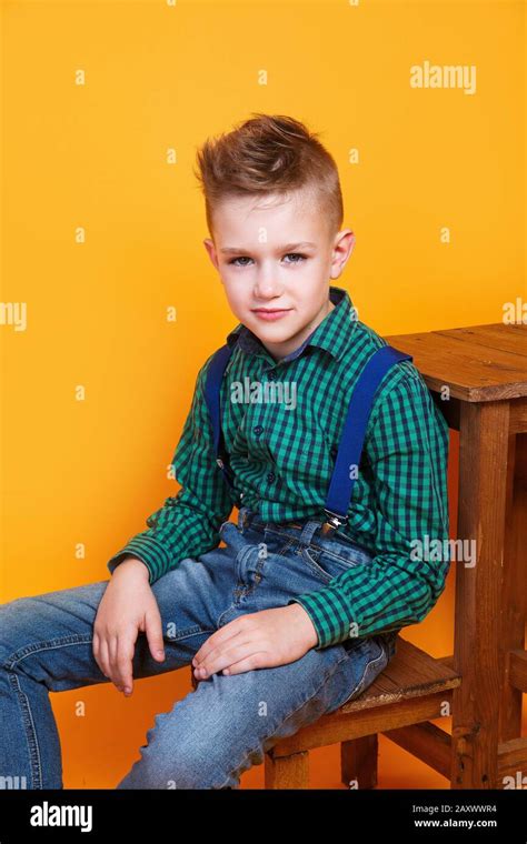 Portrait Of Cute Little Kid Boy In Stylish Jeans Clothes Looking At