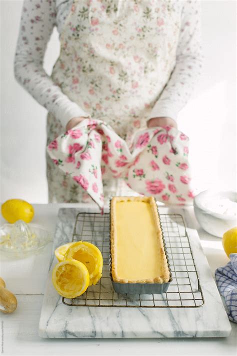 Woman Preparing A Lemon Tart Woman Placing A Freshly Baked Lemon Tart