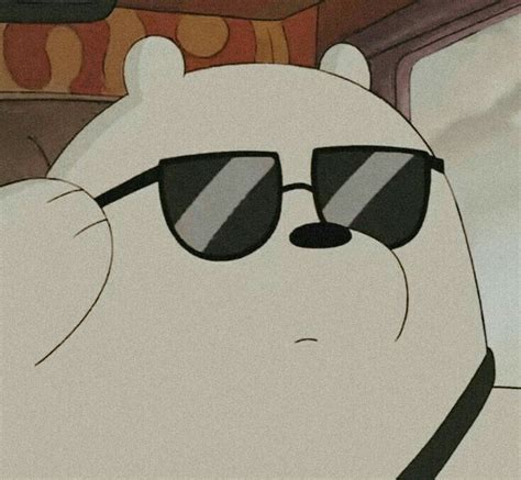 A Polar Bear Wearing Sunglasses Sitting On Top Of A Couch