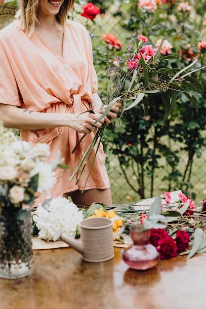 Premium Photo Woman Arranging Flowers In A Garden