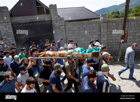 people carry the body of the victim who has been identified as zelimkhan khangoshvili a