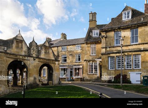 Old 17th Century Market Hall And Cotswold Stone Buildings In Historic