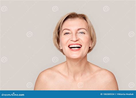 Beauty Conept Mature Woman Standing Isolated On Grey Close Up Laughing