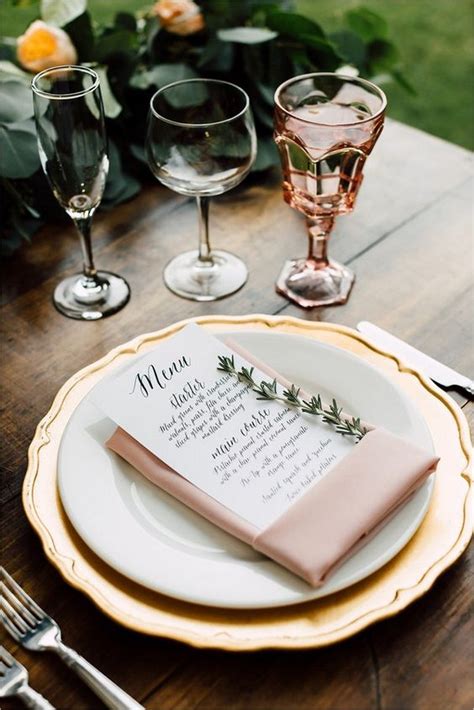 The dinner plate is in a bright gold, with a blue floral salad plate and a white napkin held together by a silver napkin ring. elegant pink and gold wedding table settings ...