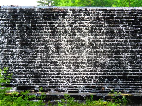 Stacked Rock Water Dam With Falling Water Wide Shot Stock Image