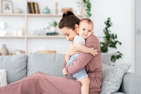 Bonding With Baby Loving Mom Cuddling Her Adorable Toddler Son At Home