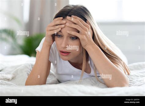 Depressed Young Woman Laying In Bed Alone At Home Stock Photo Alamy