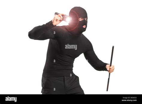 Robber With Robbery Mask Holding A Flashlight And Piece Of Pipe Stock