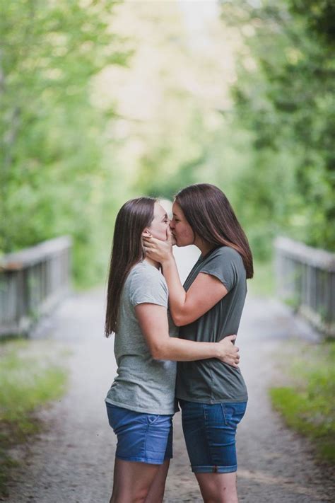 Two Young Women Are Hugging Each Other On A Path